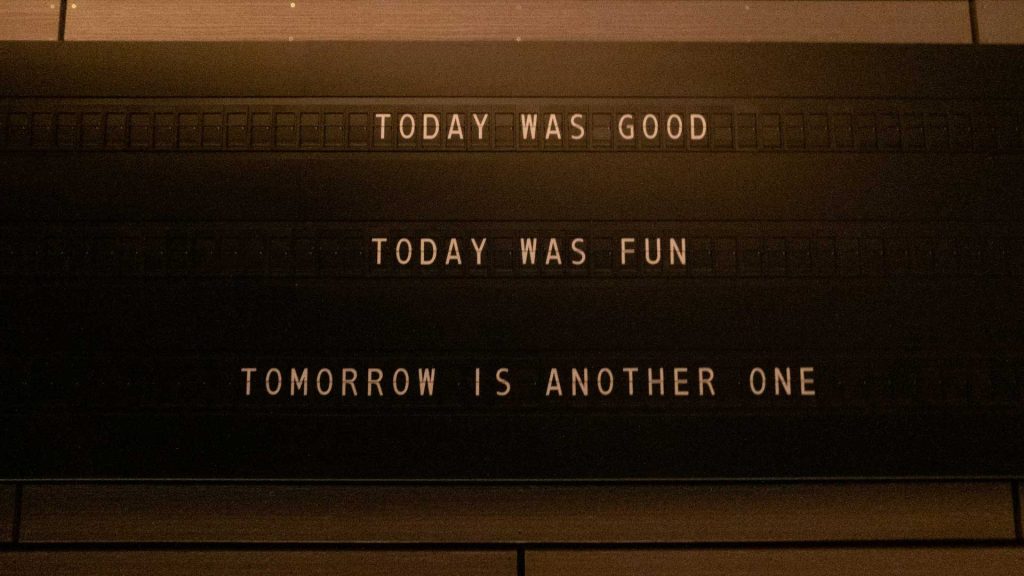 A signboard displays the phrase “Today was good. Today was fun. Tomorrow is another one.”