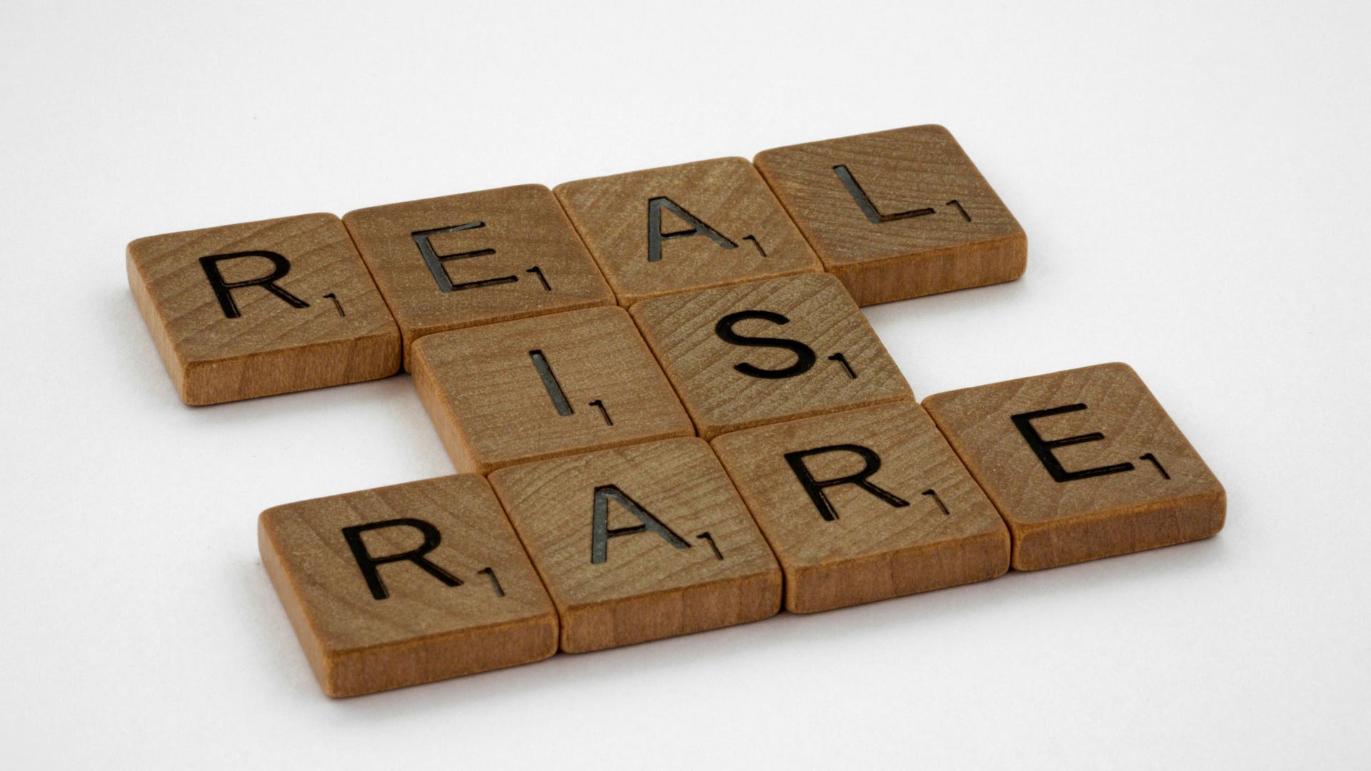 Scrabble™ tiles spell out the phrase: “Real is rare”