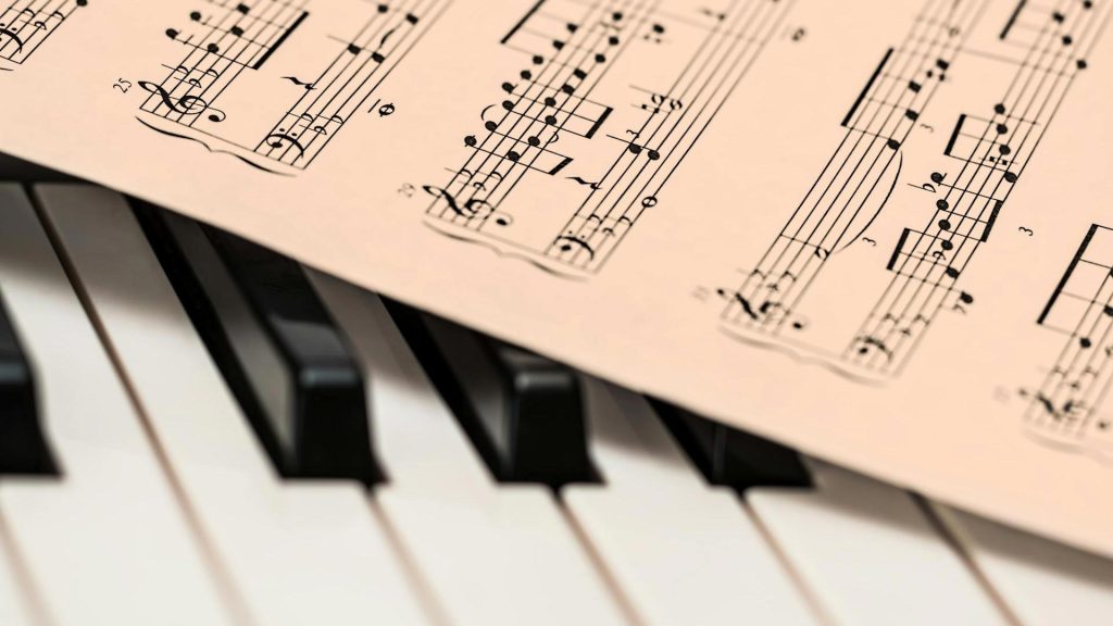 Sheet music rests on piano keys.