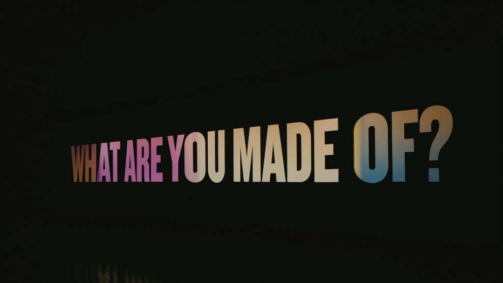 The words "What are you made of?" are displayed in multicolor against a black backdrop.